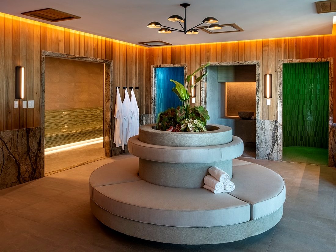 The Hydro Wellness Studio lounge, with robes, rolled towels and lit experience showers