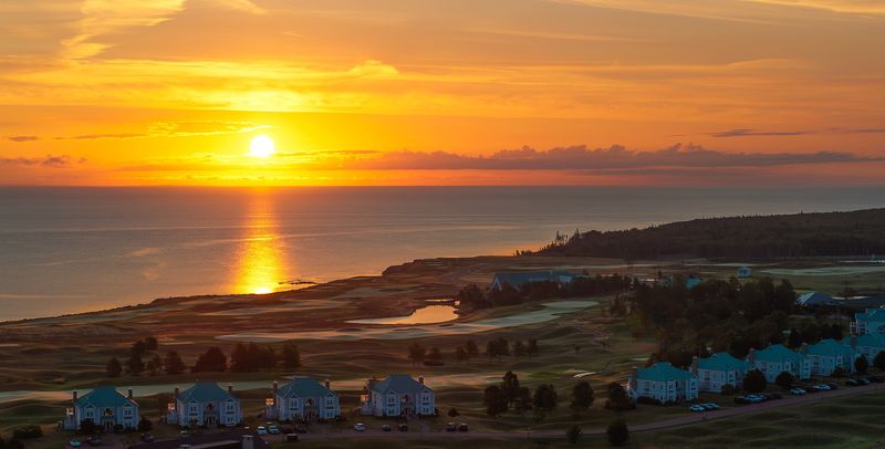 Sunset over the Strait from above the 18th hole on the Ocean Course, with resort houses in the foreground