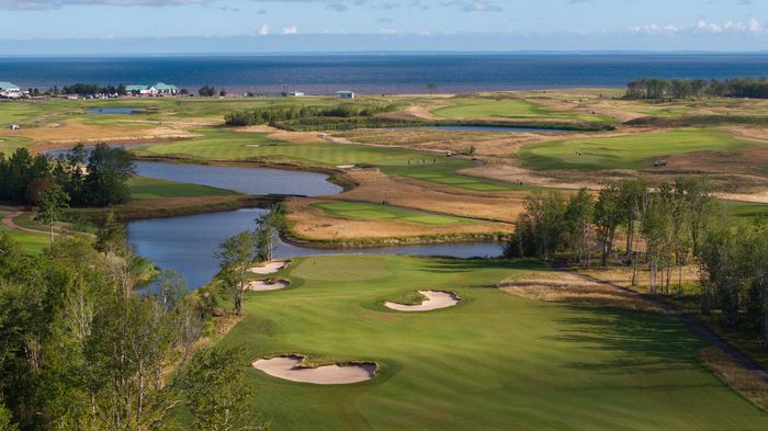Aerial view of the 8th hole on the Vineyard Course: fairway bunkers and ponds, with the Strait on the horizon
